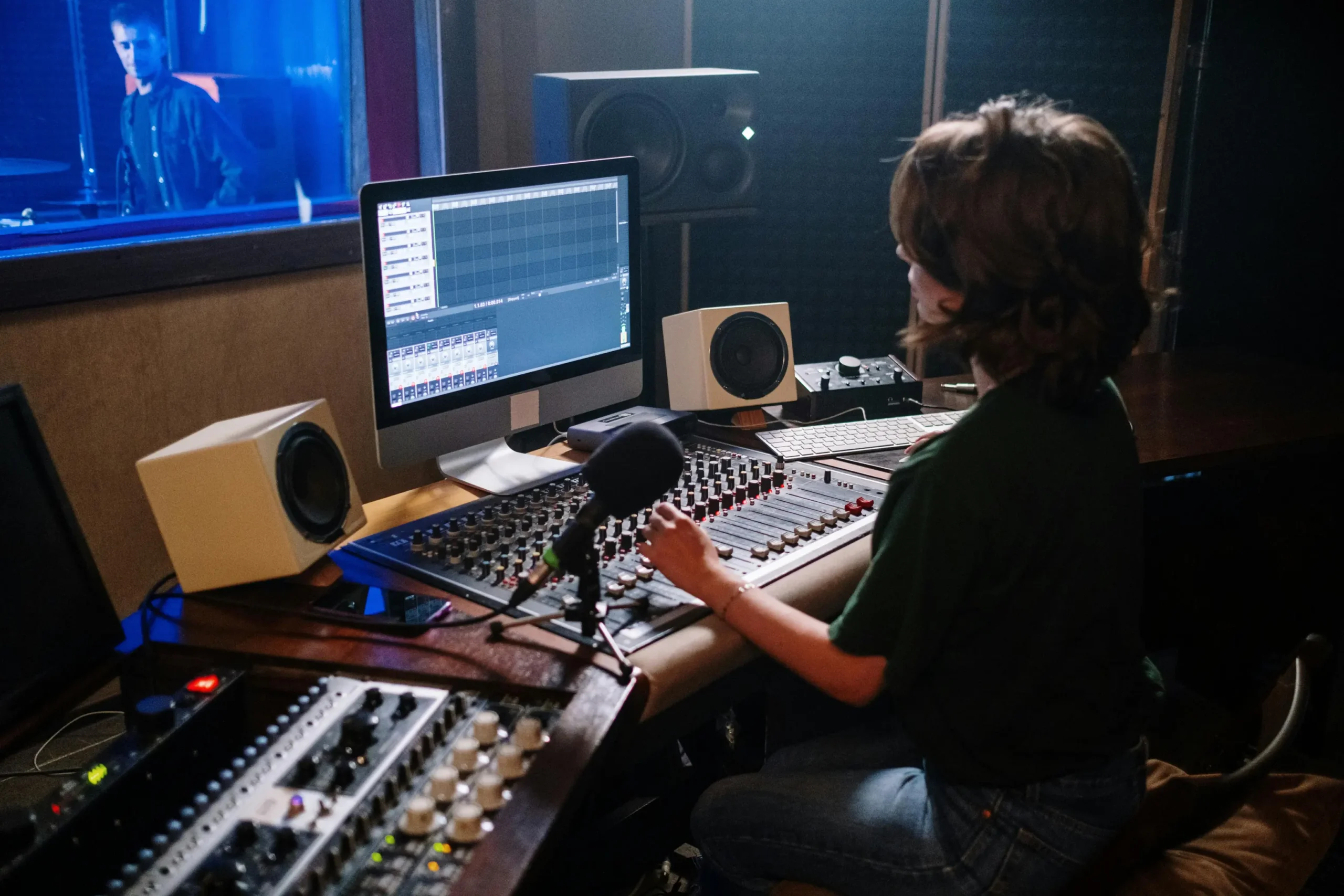 Woman at sound mixing desk in voiceover.cafe voiceover agency recording a commercial voiceover